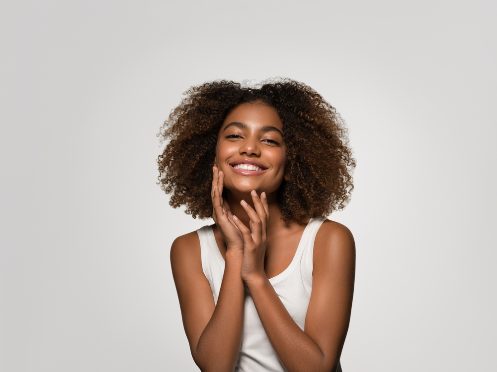 Woman smiling after socket preservation procedure in Deer Park, TX