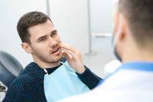 man in dental office with dental pain